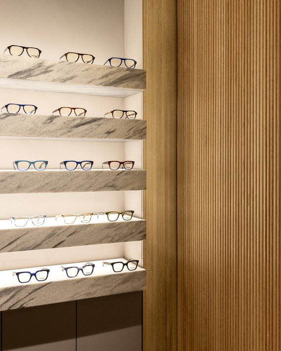 Image of the New York Store, showing glasses frames on marble shelving.