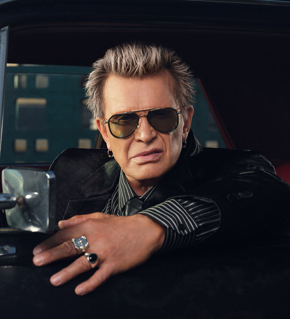 An Image of Billy Idol wearing The Great Frog Limited-Edition Triumph Aviator Sunglasses in Gold/Black
