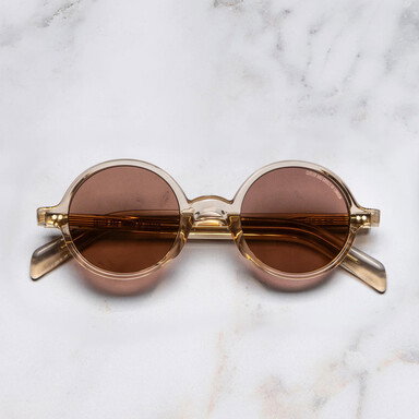 Frontal image of GR01 Round Sunglasses with marble background