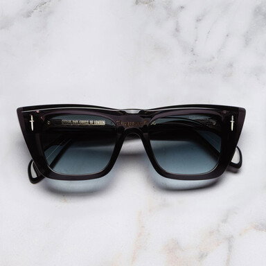 Frontal image of The Great Frog Love And Death Cat Eye Sunglasses with marble background